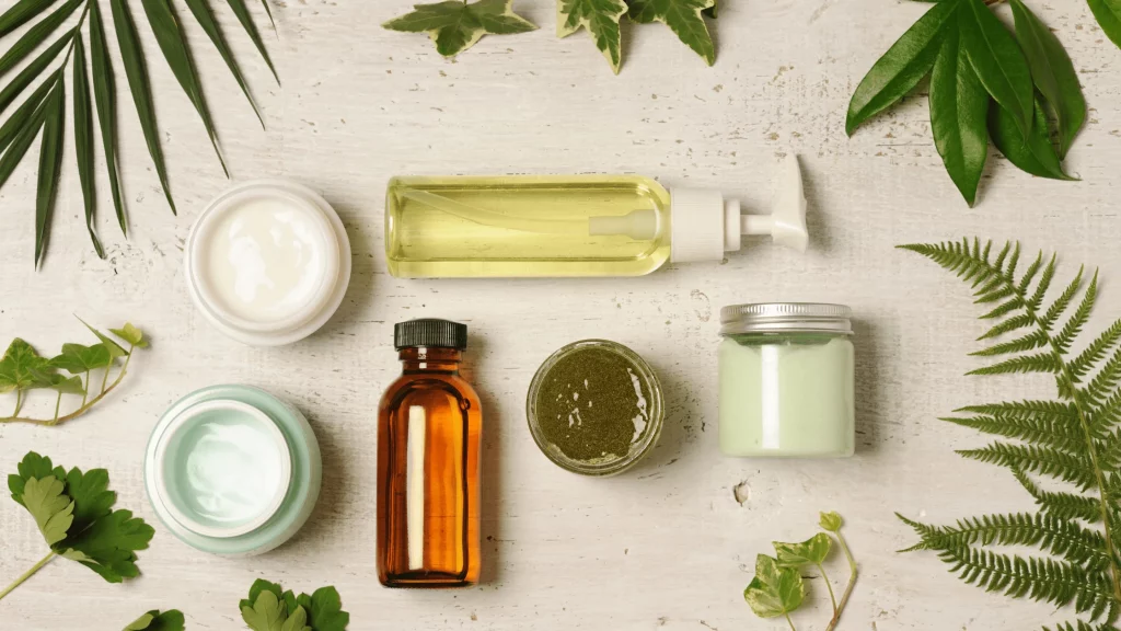 Flat lay of cosmetic containers with creams, oils, and natural leaves, representing personal care and cosmetic solutions from SBR International GmbH