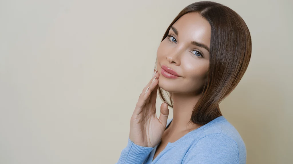 Professional portrait of a woman in a light blue sweater, representing the people and expertise behind SBR International GmbH.