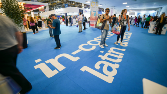 Visitors walking on blue carpet at in-cosmetics Latin America trade show, symbolizing beauty industry innovation and networking