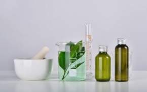 Laboratory glassware with natural extracts and liquids, symbolizing cosmetic emulsifiers in B2B specialty chemicals