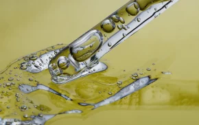 Microscopic view of emulsifiers in oil and water, representing cosmetic formulations and B2B specialty chemicals