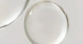 Clear glass lenses on a white surface, representing specialty chemical solutions from SBR International GmbH