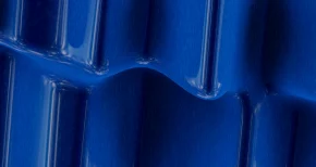 Close-up of blue textured plastic surface with raised ridges, representing industrial material solutions from SBR International GmbH